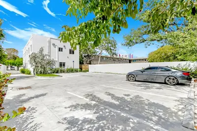 a car parked in a parking lot in front of a building at ArTease3 - stylish, near Wynwood Walls & restaurants in Miami