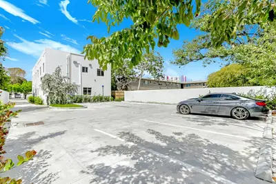 a car parked in a parking lot in front of a building at ArTease4 - stylish, near Wynwood Walls & restaurants in Miami