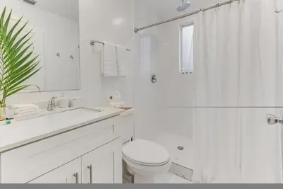 a white bathroom with a toilet and a shower at ArTease5 - stylish, near Wynwood Walls & restaurants in Miami