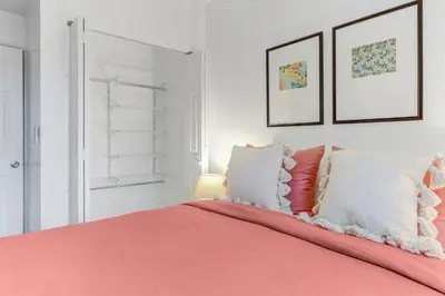 a bedroom with a bed with orange sheets and pillows at ArTease5 - stylish, near Wynwood Walls & restaurants in Miami