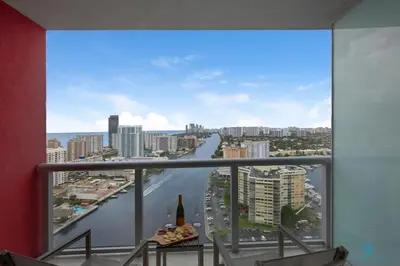 a room with a view of a river and a city at Upper studio with Balcony - Pool - Gym in Hallandale Beach