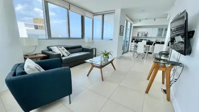 a living room with a couch and a table at Monte Carlo Suites in Miami Beach in Miami Beach