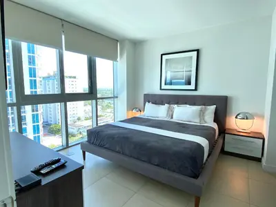 a bedroom with a bed and a large window at Monte Carlo Suites in Miami Beach in Miami Beach