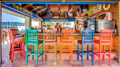 a group of colorful chairs sitting at a bar at Castle 1029 Balcony studio with Ocean View, Pool, Tennis and Free Parking in Miami Beach