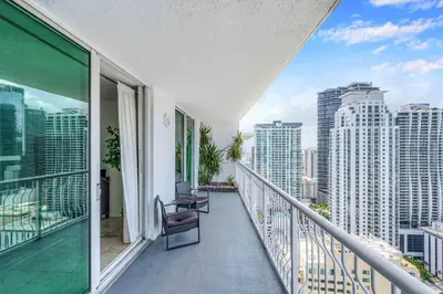 a balcony with two chairs and a view of the city at Modern 1 Bed in the Heart of Brickell With Free Parking in Miami