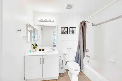 a white bathroom with a toilet and a sink at Modern 1 Bed in the Heart of Brickell With Free Parking in Miami