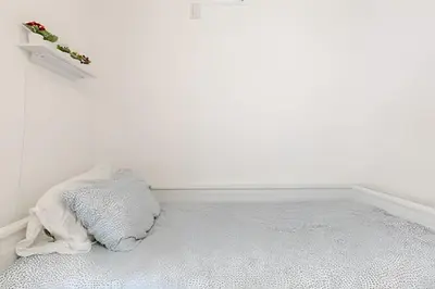 a white room with a bed and a white wall at Pavilion - Stunning bay view in Miami Beach