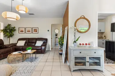 a living room with a couch and a table at 3BR Boho Style Home w Private yard & Firepit in Miami