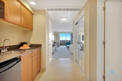 a kitchen with a hallway leading to a dining room at Luxurious Beach Resort Balcony in Sunny Isles Beach