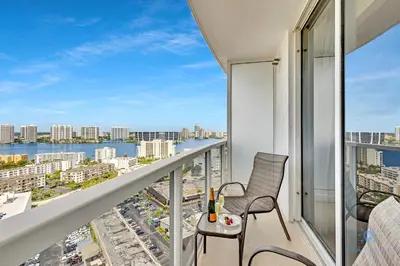 a balcony with chairs and a view of the city at Luxurious Beach Resort Balcony in Sunny Isles Beach