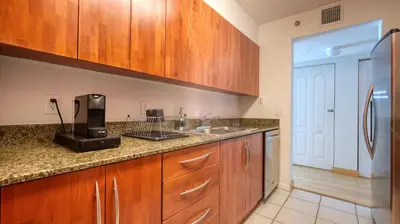 a kitchen with wooden cabinets and a sink at Beautiful Brickell Miami apt 2BR/2BA + Parking in Miami