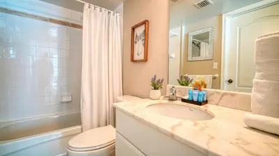 a bathroom with a sink and a toilet and a tub at Beautiful Brickell Miami apt 2BR/2BA + Parking in Miami