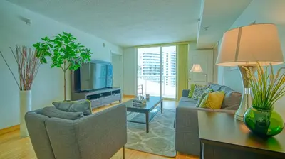 a living room with a couch and a tv at Beautiful Brickell Miami apt 2BR/2BA + Parking in Miami