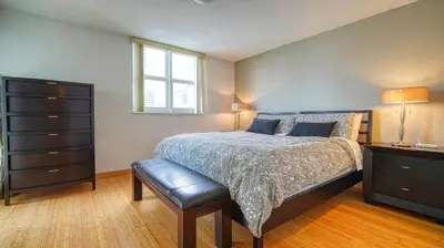 a bedroom with a bed and a dresser and a window at Beautiful Brickell Miami apt 2BR/2BA + Parking in Miami