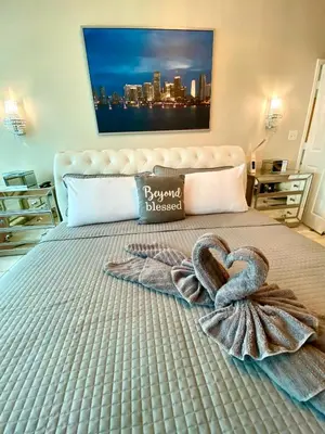 a bed with two heart shaped towels on it at Large beautiful penthouse ocean front with beach access and free parking in Miami Beach in Miami Beach