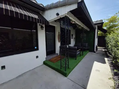 a front porch with a black and white house at Quiet Oasis Steps From Shops with Golf View-CS61 in Hollywood