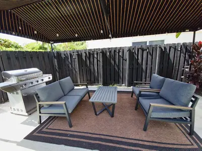a patio with two chairs and a table and a grill at Quiet Oasis Steps From Shops with Golf View-CS61 in Hollywood