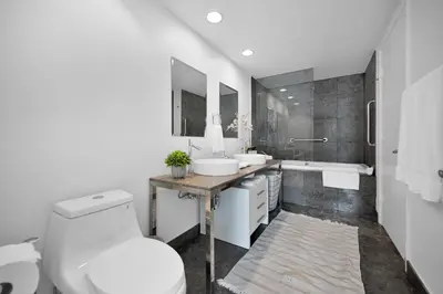 a bathroom with a toilet and a sink and a tub at Perfect One Bedroom at Icon Brickell Amazing views in Miami