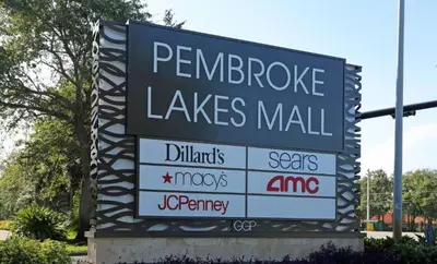 a large sign for a walmartles mall on a street at Smart Tiny House Garden in Miami Gardens