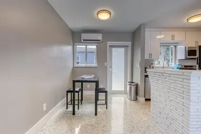 a kitchen with a table and two stools at Sunshine Manor 2017-2 in Fort Lauderdale