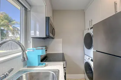 a small kitchen with a sink and a dishwasher at Sunshine Manor 2017-2 in Fort Lauderdale