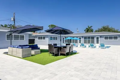 a patio with a table and chairs and umbrellas at Sunshine Manor 2017-2 in Fort Lauderdale
