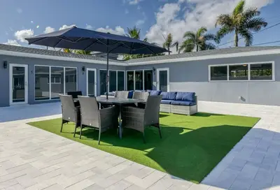 a patio with a table and chairs and an umbrella at Sunshine Manor 2017-2 in Fort Lauderdale
