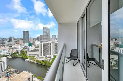 a balcony with a chair and a view of the city at Stylish Studio Icon, W Hotel Waterfront Building in Miami