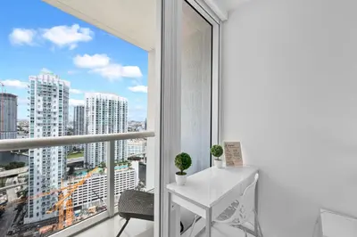a room with a window with a white table and a view at Stylish Studio Icon, W Hotel Waterfront Building in Miami