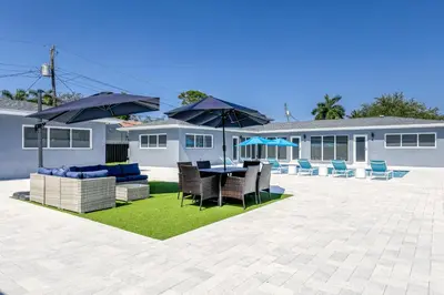 a patio with a table and chairs and umbrellas at Sunshine Manors 2013 A in Fort Lauderdale