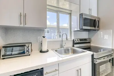 a kitchen with a sink and a microwave at Sunshine Manor 2017-1 in Fort Lauderdale