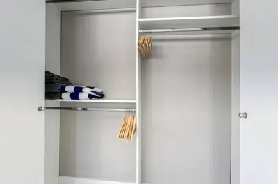 a closet with white doors and shelves at Sunshine Manor 2017-1 in Fort Lauderdale