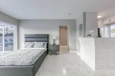 a bedroom with a large bed and a kitchen at Sunshine Manors 2025-B in Fort Lauderdale