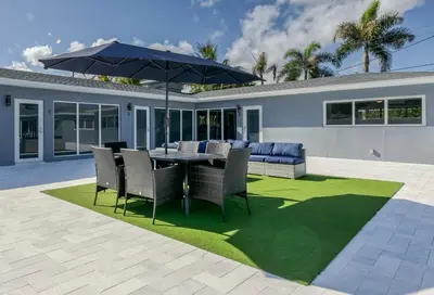 a patio with a table and chairs and an umbrella at Sunshine Manors 2009 A in Fort Lauderdale