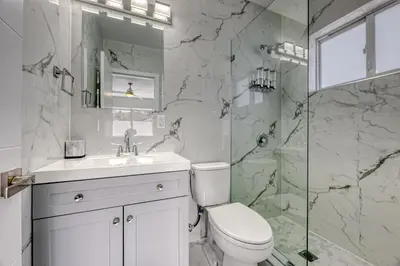 a white bathroom with a toilet and a shower at Sunshine Manors 2013 B in Fort Lauderdale