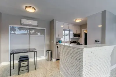 a kitchen with a counter and a table in a room at Sunshine Manor 2025-C in Fort Lauderdale