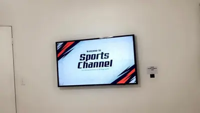 a flat screen tv hanging on a wall at BOOK ME, 3mins Hard Rock Stadium in Miami Gardens