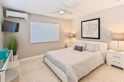 a bedroom with a white bed and a window at Wiltonplex Complex in Fort Lauderdale