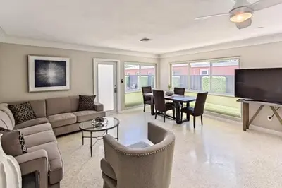a living room with a couch and a table and chairs at Wiltonplex Complex in Fort Lauderdale