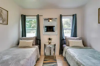 a bedroom with two beds and a mirror at Stylish Miami Home 2 Mi to Intracoastal Waterway! in Miami