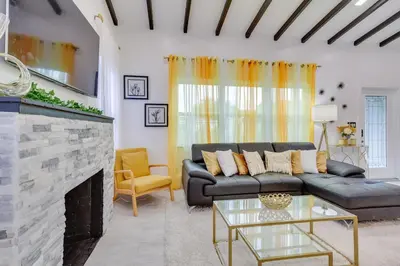 a living room with a couch and a fireplace at Stylish Miami Home 2 Mi to Intracoastal Waterway! in Miami