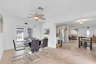a kitchen and dining room with a table and chairs at Stunning Hollywood Pool Home in Hollywood