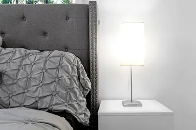a bedroom with a bed and a lamp on a night stand at Stunning Hollywood Pool Home in Hollywood