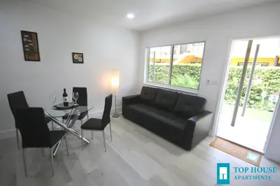 a living room with a black couch and a table at 251 Airport/Top House Apartments in Miami