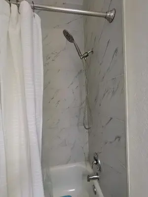 a bathroom with a shower with a white shower curtain at Mango Haus Near Beach, Cruise Port & Stadium in Fort Lauderdale