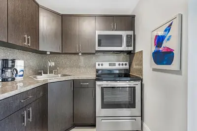 a kitchen with a stove and a microwave at Waterfront Studio Condo in the Heart of Miami - Skyline & Bay Views in Miami Beach