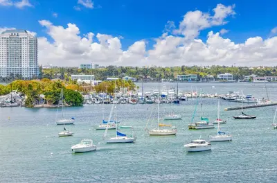 a bunch of boats are sitting in the water at Waterfront Studio Condo in the Heart of Miami - Skyline & Bay Views in Miami Beach