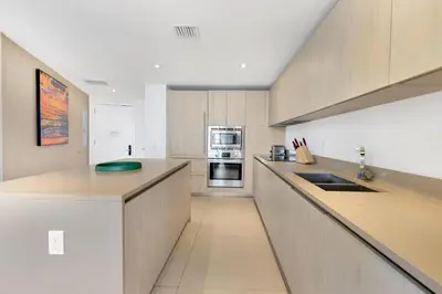 a kitchen with a counter and a stove top oven at Ocean View Balcony with Pool Gym Access in Hallandale Beach
