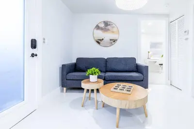 a living room with a blue couch and a table at Serenity Lodge II Condo in Miami