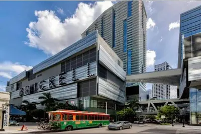 a green bus parked in front of a building at Serenity Lodge II Condo in Miami